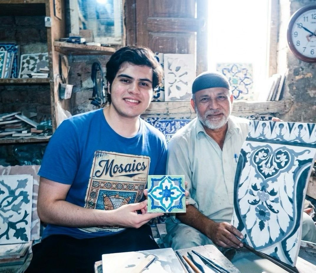Ustad Wajid and son Ubaid in the workshop holding Kashikari tiles